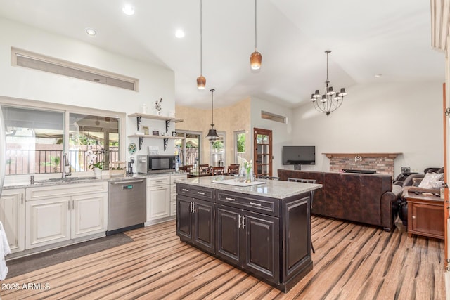 15825 N 45th St, Phoenix, AZ 85032 - kitchen with stainless steel appliances, a sink, light wood finished floors, white cabinets, and high vaulted ceiling