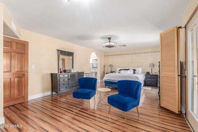 15825 N 45th St, Phoenix, AZ 85032 - bedroom featuring wood finished floors, arched walkways, and baseboards