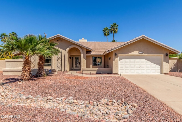 15825 N 45th St, Phoenix, AZ 85032 - mediterranean / spanish-style house featuring stucco siding, an attached garage, driveway, a tile roof, and a chimney