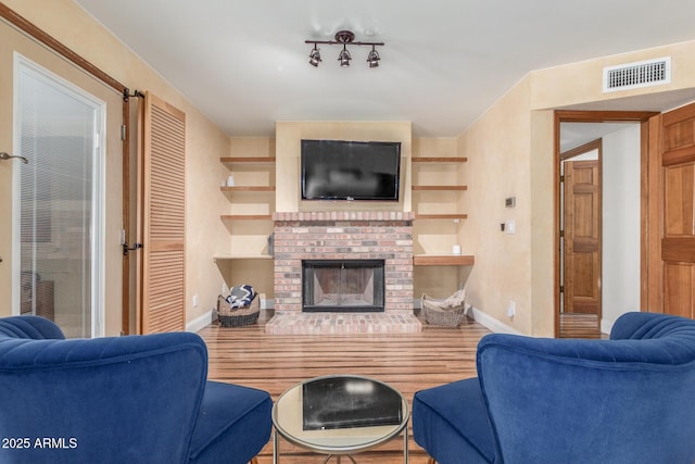 15825 N 45th St, Phoenix, AZ 85032 - living area with wood finished floors, baseboards, and a brick fireplace