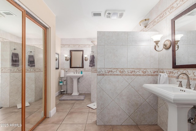 15825 N 45th St, Phoenix, AZ 85032 - bathroom featuring tile walls, tile patterned floors, tiled shower, and a sink