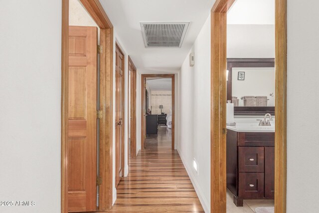 15825 N 45th St, Phoenix, AZ 85032 - hall with light wood-style flooring, a sink, and baseboards