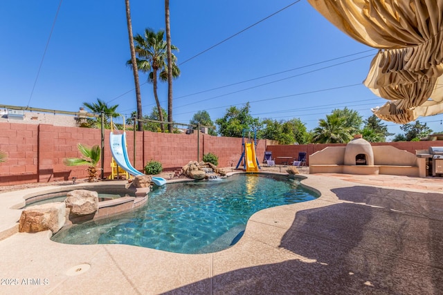 15825 N 45th St, Phoenix, AZ 85032 - view of swimming pool featuring a water slide, a fenced backyard, a patio area, area for grilling, and a pool with connected hot tub