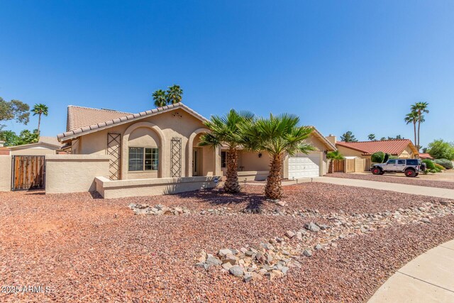 15825 N 45th St, Phoenix, AZ 85032 - mediterranean / spanish-style house with driveway, an attached garage, stucco siding, a tiled roof, and a gate