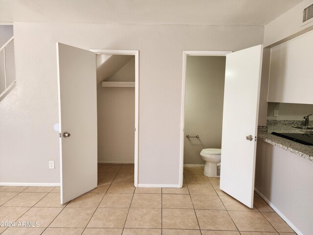 bathroom with tile patterned flooring and toilet