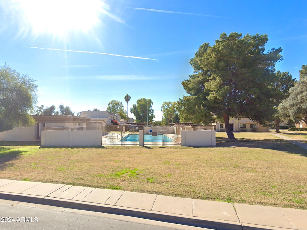 exterior space with a fenced in pool