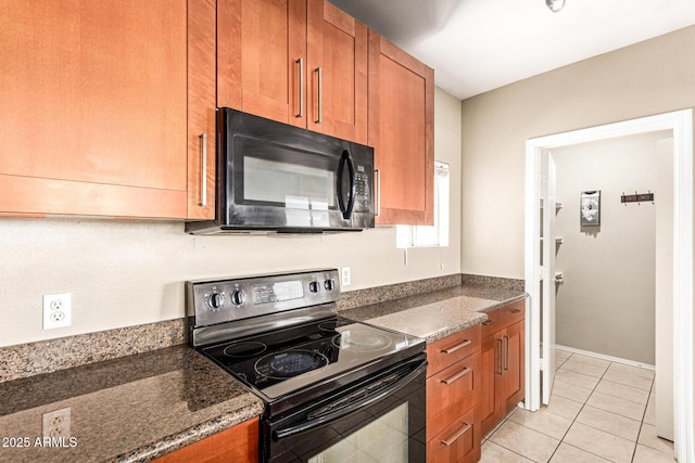 2134 E Broadway Rd Unit 2030, Tempe, AZ 85282 - kitchen featuring black appliances, brown cabinetry, dark stone countertops, and light tile patterned flooring
