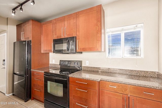2134 E Broadway Rd Unit 2030, Tempe, AZ 85282 - kitchen featuring black appliances, light tile patterned flooring, light stone countertops, brown cabinetry, and rail lighting
