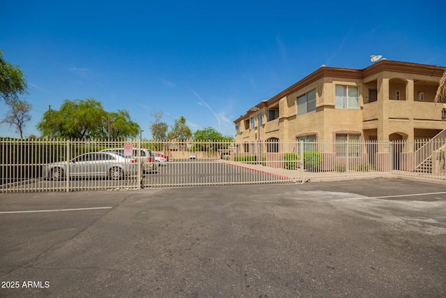 2134 E Broadway Rd Unit 2030, Tempe, AZ 85282 - uncovered parking lot featuring a gate