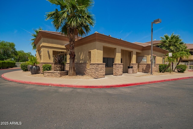2134 E Broadway Rd Unit 2030, Tempe, AZ 85282 - view of front facade featuring stone siding and stucco siding