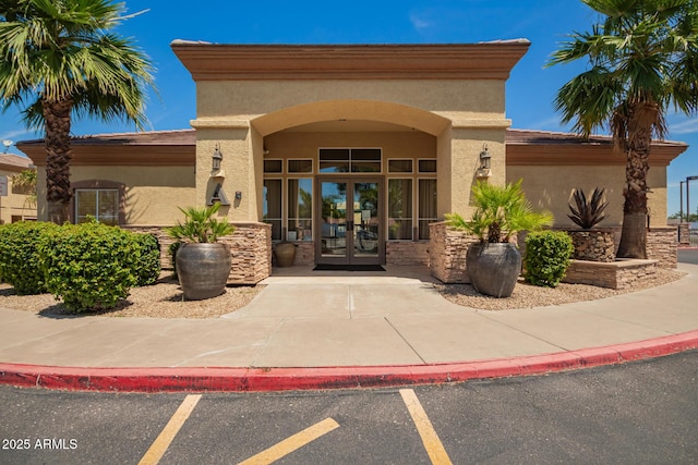2134 E Broadway Rd Unit 2030, Tempe, AZ 85282 - view of exterior entry with french doors, stucco siding, and stone siding