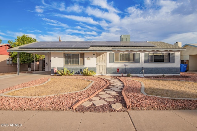 single story home featuring solar panels