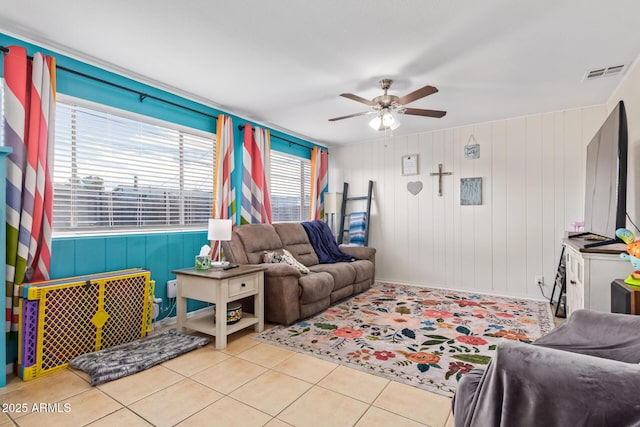 tiled living room with ceiling fan