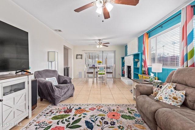 living room featuring ceiling fan and light tile patterned floors