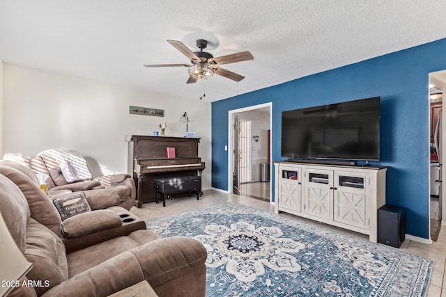 living room featuring light tile patterned flooring, a textured ceiling, and ceiling fan