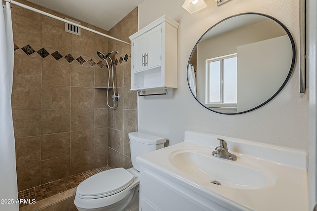 11210 S Bannock St, Phoenix, AZ 85044 - full bathroom with toilet, visible vents, a tile shower, and vanity