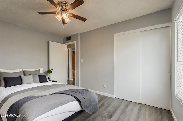 11210 S Bannock St, Phoenix, AZ 85044 - bedroom with ceiling fan, visible vents, wood finished floors, baseboards, and a closet