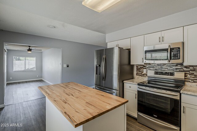 11210 S Bannock St, Phoenix, AZ 85044 - kitchen with butcher block countertops, a ceiling fan, decorative backsplash, and appliances with stainless steel finishes