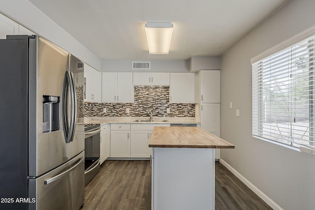 11210 S Bannock St, Phoenix, AZ 85044 - kitchen featuring visible vents, tasteful backsplash, butcher block counters, stainless steel appliances, and dark wood-type flooring