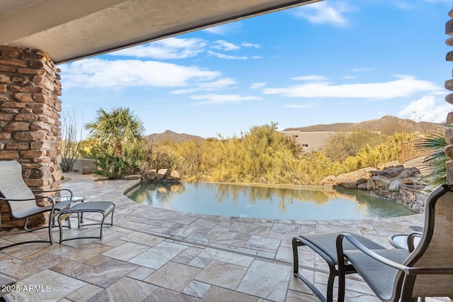 view of patio / terrace featuring a water and mountain view