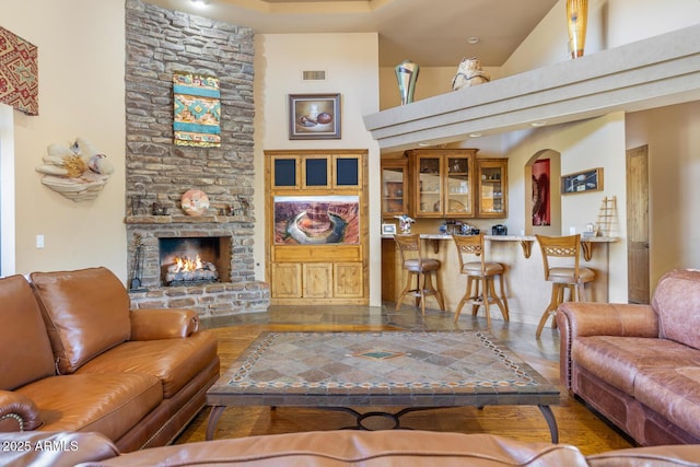 living room with a high ceiling and a fireplace