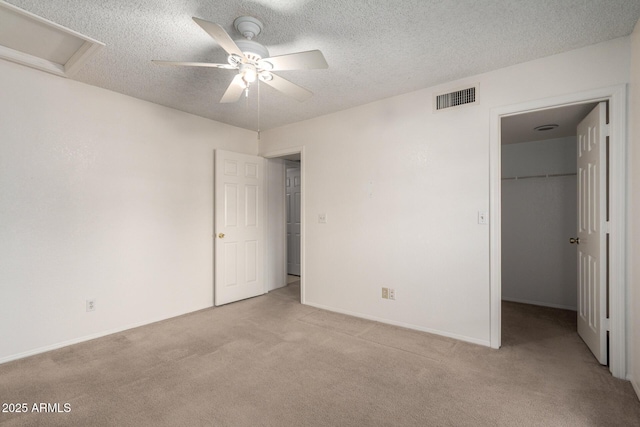 10235 N 31st St Unit 2, Phoenix, AZ 85028 - unfurnished bedroom with attic access, light carpet, a walk in closet, a textured ceiling, and a closet