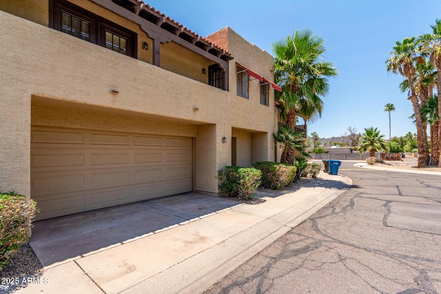 10235 N 31st St Unit 2, Phoenix, AZ 85028 - view of front of property featuring stucco siding, concrete driveway, and an attached garage