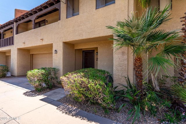 10235 N 31st St Unit 2, Phoenix, AZ 85028 - view of exterior entry featuring a garage and stucco siding