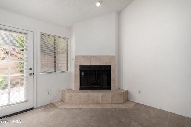 10235 N 31st St Unit 2, Phoenix, AZ 85028 - unfurnished living room with carpet flooring, a fireplace, a textured ceiling, and lofted ceiling