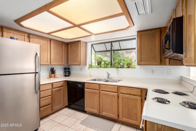 10235 N 31st St Unit 2, Phoenix, AZ 85028 - kitchen with freestanding refrigerator, black dishwasher, light countertops, and light tile patterned floors