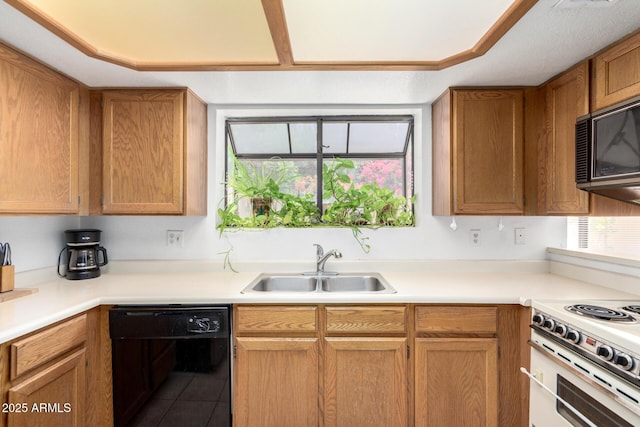10235 N 31st St Unit 2, Phoenix, AZ 85028 - kitchen with black dishwasher, white range oven, light countertops, tile patterned flooring, and brown cabinets