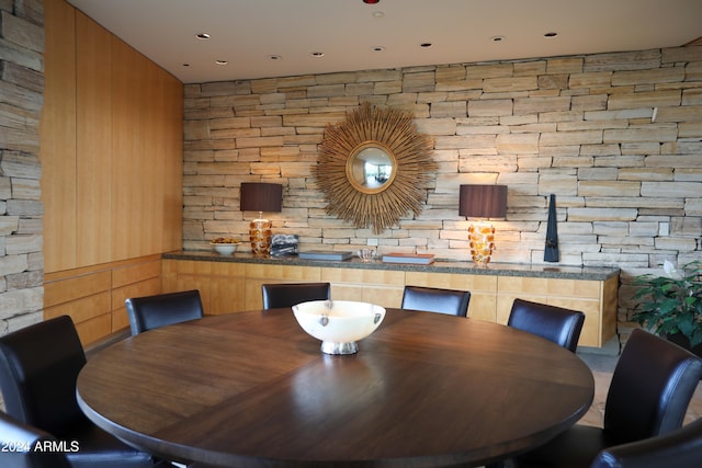 dining room featuring wooden walls