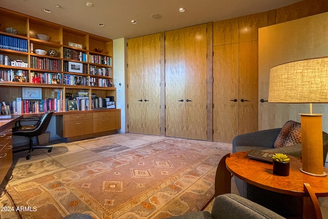 home office with wooden walls and built in shelves