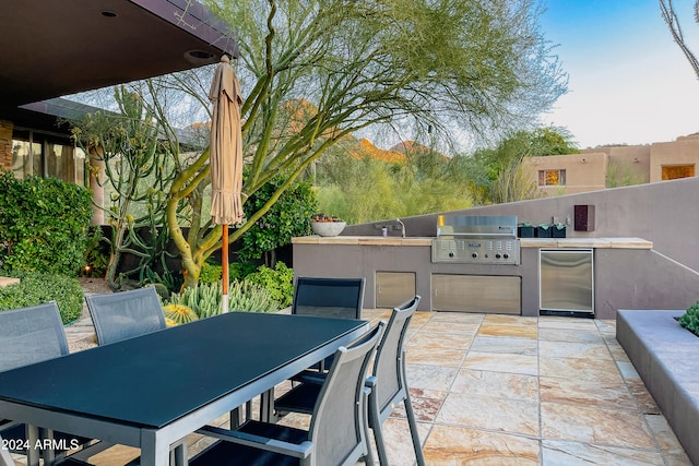 view of patio with area for grilling and a grill