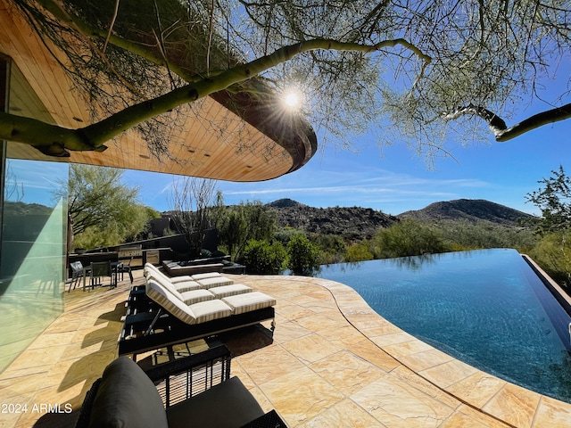 view of patio / terrace featuring a water and mountain view