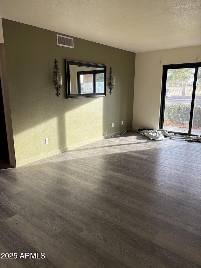 empty room featuring hardwood / wood-style floors and a textured ceiling