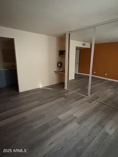 interior space with dark wood-type flooring and a closet