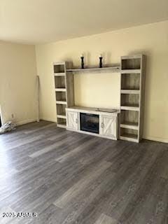 unfurnished living room featuring dark wood-type flooring