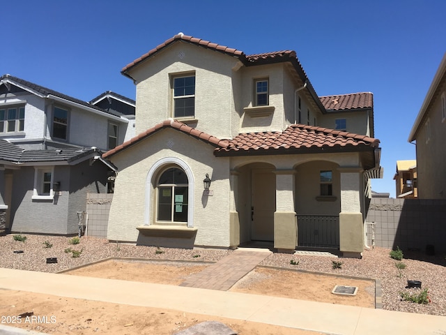 13481 N 158th Ave, Surprise, AZ 85379 - mediterranean / spanish-style home with a tiled roof, stucco siding, fence, and covered porch