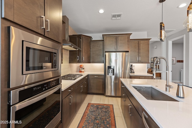 24226 N 22nd St, Phoenix, AZ 85024 - kitchen featuring appliances with stainless steel finishes, a sink, light countertops, backsplash, and dark brown cabinetry