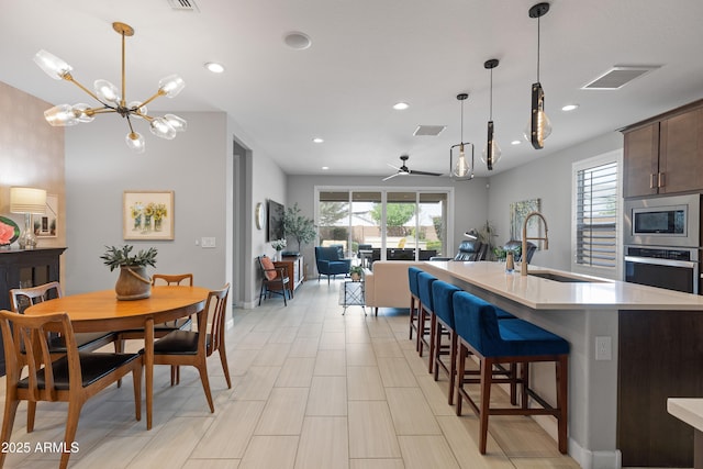24226 N 22nd St, Phoenix, AZ 85024 - kitchen with stainless steel appliances, light countertops, recessed lighting, pendant lighting, and a kitchen island with sink