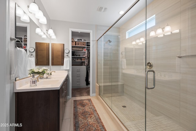24226 N 22nd St, Phoenix, AZ 85024 - bathroom featuring double vanity, a spacious closet, tile patterned flooring, and a stall shower