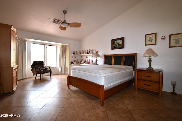 tiled bedroom with lofted ceiling, visible vents, and a ceiling fan