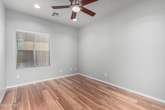 spare room with ceiling fan and wood-type flooring