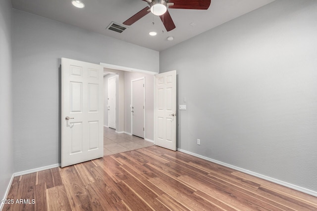 unfurnished bedroom featuring ceiling fan and light hardwood / wood-style flooring