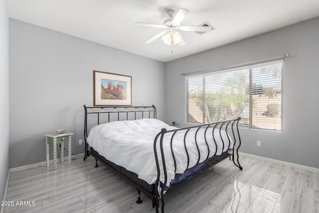 bedroom with ceiling fan and light wood-type flooring