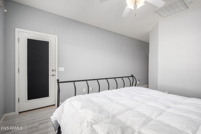 bedroom with ceiling fan and light hardwood / wood-style floors