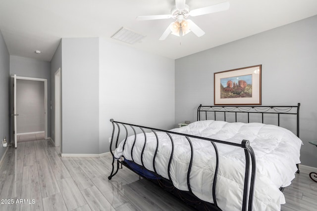 bedroom with ceiling fan and light hardwood / wood-style flooring