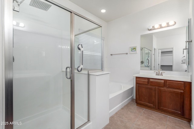 bathroom with tile patterned floors, vanity, and separate shower and tub