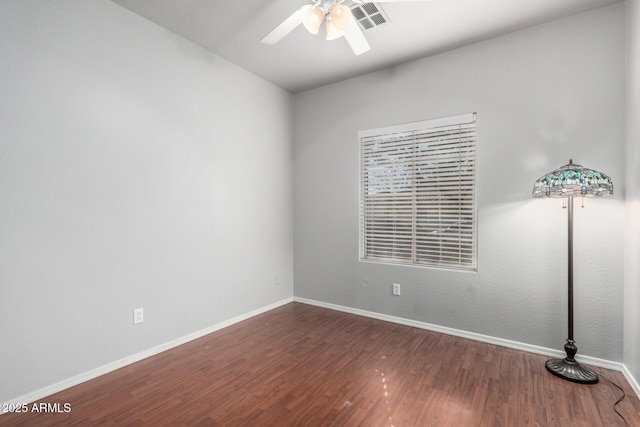 empty room featuring ceiling fan and dark hardwood / wood-style floors